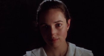 Movie still from “Barcelona” (1994), directed by Whit Stillman – A woman's face in a dark room; Close Up shot, High angle