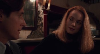 Movie still from “Barcelona” (1994), directed by Whit Stillman – A woman sitting in front of a mirror in front of a fireplace; Close Up shot, Over the shoulder angle