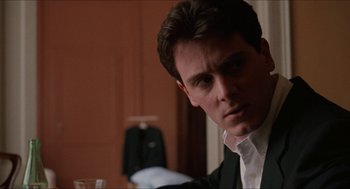 Movie still from “Barcelona” (1994), directed by Whit Stillman – A person wearing a suit and tie; Close Up shot, Over the shoulder angle