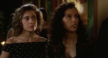Movie still from “Barcelona” (1994), directed by Whit Stillman – Two young women are standing next to each other; Close Up shot, Over the shoulder angle