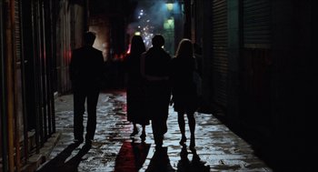 Movie still from “Barcelona” (1994), directed by Whit Stillman – A group of people walking down a street at night; Wide shot, High angle
