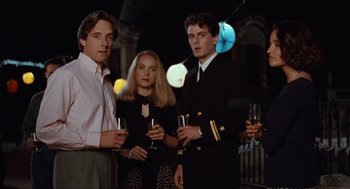 Movie still from “Barcelona” (1994), directed by Whit Stillman – A group of people standing next to each other holding wine glasses; Medium shot, Low angle