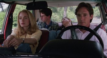 Movie still from “Barcelona” (1994), directed by Whit Stillman – A group of people sitting in the back of a car; Medium shot, High angle