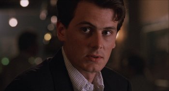 Movie still from “Barcelona” (1994), directed by Whit Stillman – A person wearing a suit and tie; Close Up shot, Over the shoulder angle