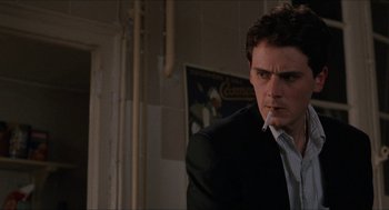 Movie still from “Barcelona” (1994), directed by Whit Stillman – A man smoking a cigarette while wearing a suit; Close Up shot, Low angle