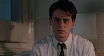 Movie still from “Barcelona” (1994), directed by Whit Stillman – A man in a white dress shirt and a tie; Close Up shot, Low angle
