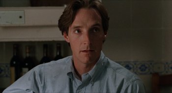 Movie still from “Barcelona” (1994), directed by Whit Stillman – A person wearing a blue shirt; Close Up shot, Over the shoulder angle