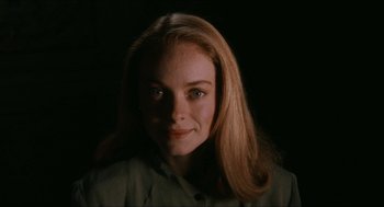 Movie still from “Barcelona” (1994), directed by Whit Stillman – A woman with long blonde hair is smiling for the camera; Close Up shot, Low angle