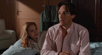 Movie still from “Barcelona” (1994), directed by Whit Stillman – A man and a woman sitting next to each other in a room; Medium shot, Low angle