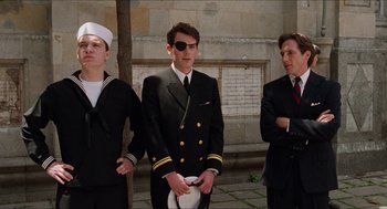 Movie still from “Barcelona” (1994), directed by Whit Stillman – A group of men standing next to each other on a sidewalk; Medium shot, Low angle