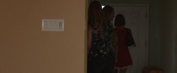 Movie still from “Bare” (2015), directed by Natalia Leite – A group of people standing next to each other in a room; Medium shot, Over the shoulder angle