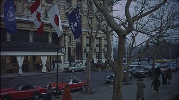 Movie still from “Barefoot in the Park” (1967), directed by Gene Saks – Cars parked on the side of the road near a building; Extreme Wide shot, High angle