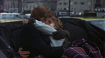 Movie still from “Barefoot in the Park” (1967), directed by Gene Saks – A man and a woman hugging each other on a bench; Medium shot, Over the shoulder angle
