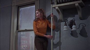 Movie still from “Barefoot in the Park” (1967), directed by Gene Saks – A young woman holding a pole in a room with a window; Medium shot, Low angle
