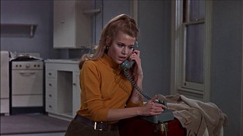 Movie still from “Barefoot in the Park” (1967), directed by Gene Saks – A woman talking on a phone while holding a suitcase; Medium shot, Low angle