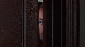 Movie still from “Barefoot in the Park” (1967), directed by Gene Saks – A woman peeking through a metal door; Extreme Close Up shot, Low angle