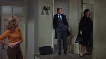 Movie still from “Barefoot in the Park” (1967), directed by Gene Saks – A man in a suit standing in front of a woman; Wide shot, Low angle