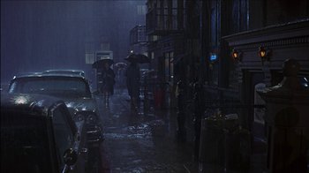 Movie still from “Barefoot in the Park” (1967), directed by Gene Saks – A group of people walking down a street in the rain; Extreme Wide shot, High angle