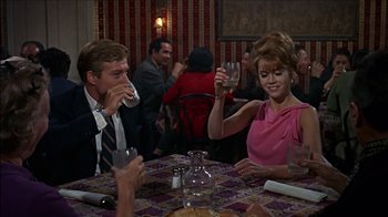 Movie still from “Barefoot in the Park” (1967), directed by Gene Saks – A group of people sitting at a table drinking wine; Medium shot, Over the shoulder angle