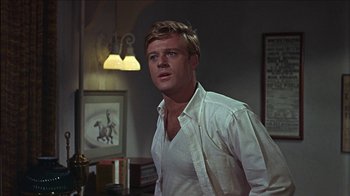 Movie still from “Barefoot in the Park” (1967), directed by Gene Saks – A man standing in a room with a horse on the wall behind him; Close Up shot, Over the shoulder angle