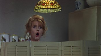 Movie still from “Barefoot in the Park” (1967), directed by Gene Saks – A woman standing in front of a wooden fence; Medium shot, Low angle