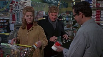 Movie still from “Barefoot in the Park” (1967), directed by Gene Saks – A couple of people standing in front of a grocery store; Medium shot, Over the shoulder angle