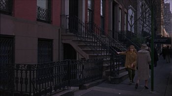 Movie still from “Barefoot in the Park” (1967), directed by Gene Saks – A woman walking down the sidewalk in front of a fire escape; Wide shot, High angle