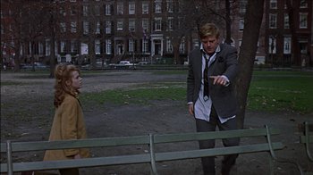 Movie still from “Barefoot in the Park” (1967), directed by Gene Saks – A man and a woman standing next to each other on a park bench; Medium shot, Over the shoulder angle