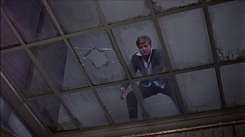 Movie still from “Barefoot in the Park” (1967), directed by Gene Saks – A man in a suit and tie standing inside a building; Medium shot, Low angle