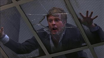 Movie still from “Barefoot in the Park” (1967), directed by Gene Saks – A man in a suit is looking through a broken glass window; Close Up shot, Low angle