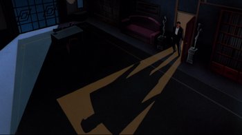 Movie still from “Batman: Mask of the Phantasm” (1993), directed by Kevin Altieri – A man standing in a dark room casting a shadow on the floor; Extreme Wide shot, High angle