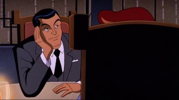 Movie still from “Batman: Mask of the Phantasm” (1993), directed by Kevin Altieri – A man sitting in front of a computer screen; Medium shot, Over the shoulder angle