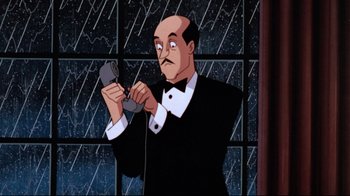 Movie still from “Batman: Mask of the Phantasm” (1993), directed by Kevin Altieri – A bald man in a suit holding a cell phone; Medium shot, Low angle