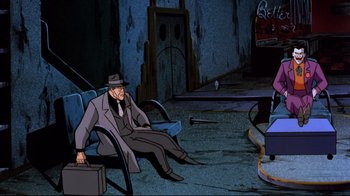 Movie still from “Batman: Mask of the Phantasm” (1993), directed by Kevin Altieri – An old man sitting in a chair in a room; Wide shot, High angle