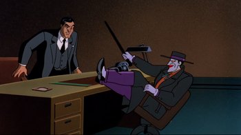 Movie still from “Batman: Mask of the Phantasm” (1993), directed by Kevin Altieri – A man sitting at a desk in front of another man in a suit; Wide shot, High angle