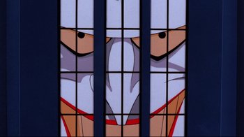 Movie still from “Batman: Mask of the Phantasm” (1993), directed by Kevin Altieri – A cartoon character behind bars; Extreme Close Up shot, Low angle