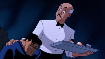 Movie still from “Batman: Mask of the Phantasm” (1993), directed by Kevin Altieri – A man holding a silver tray in front of a man; Medium shot, Over the shoulder angle