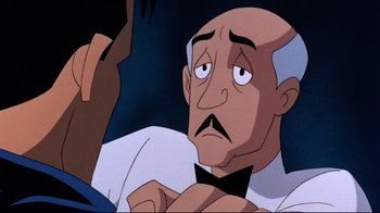 Movie still from “Batman: Mask of the Phantasm” (1993), directed by Kevin Altieri – An old man with a bow tie is looking at the camera; Close Up shot, Over the shoulder angle