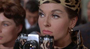 Movie still from “Batman: The Movie” (1966), directed by Leslie H. Martinson – A person holding a camera; Close Up shot, Low angle
