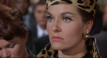 Movie still from “Batman: The Movie” (1966), directed by Leslie H. Martinson – A person wearing a leopard print headpiece; Close Up shot, Low angle