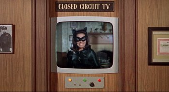 Movie still from “Batman: The Movie” (1966), directed by Leslie H. Martinson – A woman dressed as catwoman is sitting in front of a television; Extreme Close Up shot, High angle
