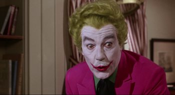 Movie still from “Batman: The Movie” (1966), directed by Leslie H. Martinson – A man in a joker costume with green hair; Close Up shot, Low angle