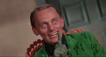 Movie still from “Batman: The Movie” (1966), directed by Leslie H. Martinson – A person sitting in a chair; Close Up shot, Low angle