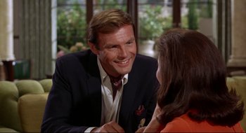 Movie still from “Batman: The Movie” (1966), directed by Leslie H. Martinson – A man and a woman are talking to each other; Close Up shot, Over the shoulder angle