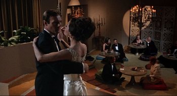 Movie still from “Batman: The Movie” (1966), directed by Leslie H. Martinson – A man and a woman dancing in a living room; Wide shot, High angle