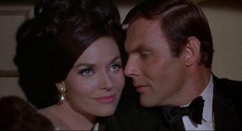 Movie still from “Batman: The Movie” (1966), directed by Leslie H. Martinson – A man and a woman are looking at each other; Close Up shot, Low angle
