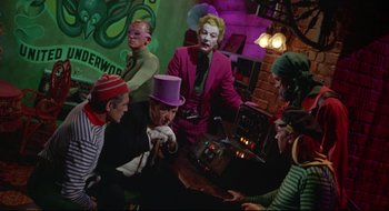 Movie still from “Batman: The Movie” (1966), directed by Leslie H. Martinson – A group of people dressed up in costumes; Medium shot, High angle