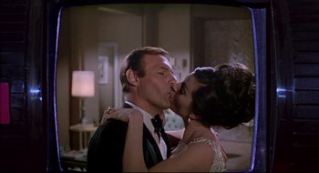 Movie still from “Batman: The Movie” (1966), directed by Leslie H. Martinson – A man and a woman kissing each other in front of a mirror; Close Up shot, Low angle