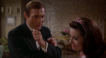 Movie still from “Batman: The Movie” (1966), directed by Leslie H. Martinson – A man and a woman are looking at each other; Close Up shot, Low angle