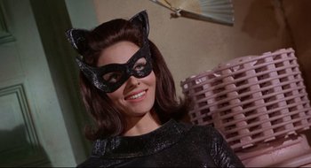 Movie still from “Batman: The Movie” (1966), directed by Leslie H. Martinson – A woman wearing a cat mask and smiling for the camera; Close Up shot, Low angle